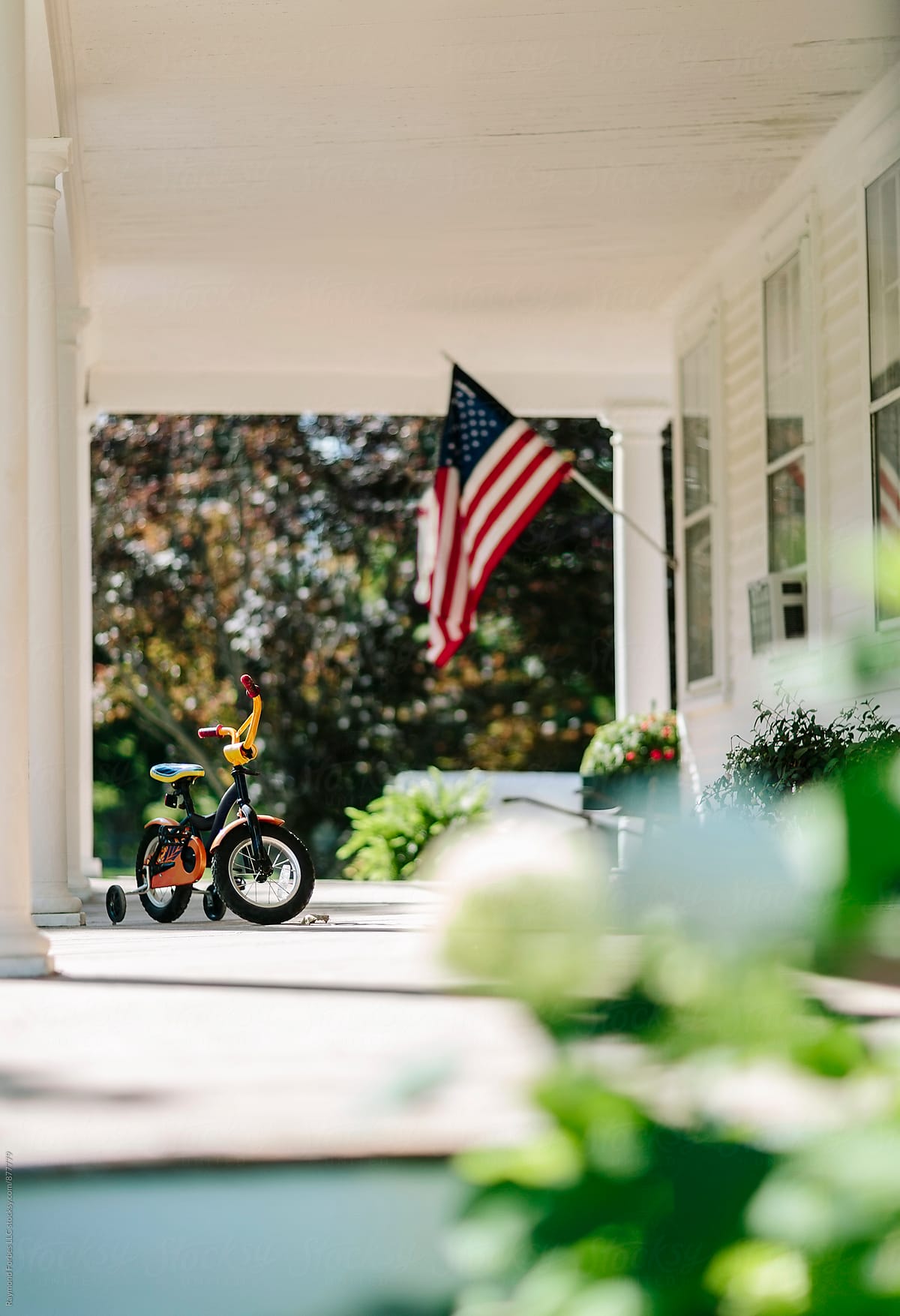 Front Porch of Home with American Flag with bike