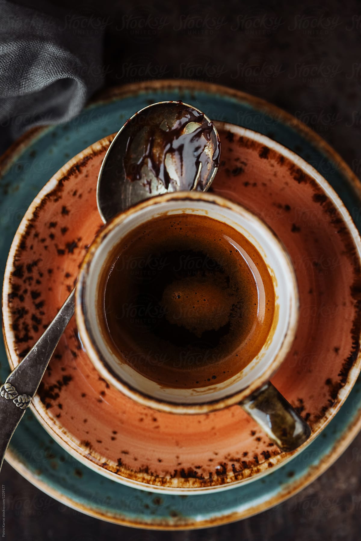 Cup of espresso and chocolate stained spoon
