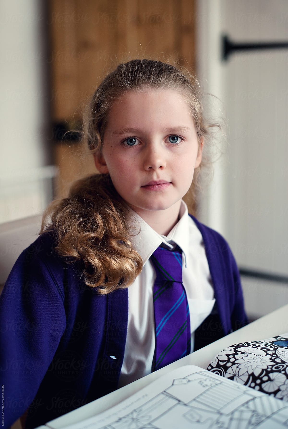 Schoolgirl sitting at the table after school