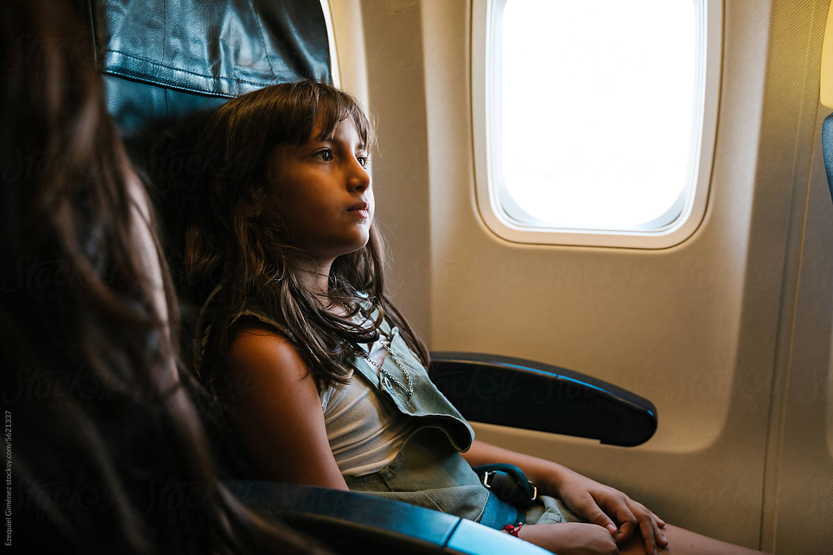 Girl on chair in airplane