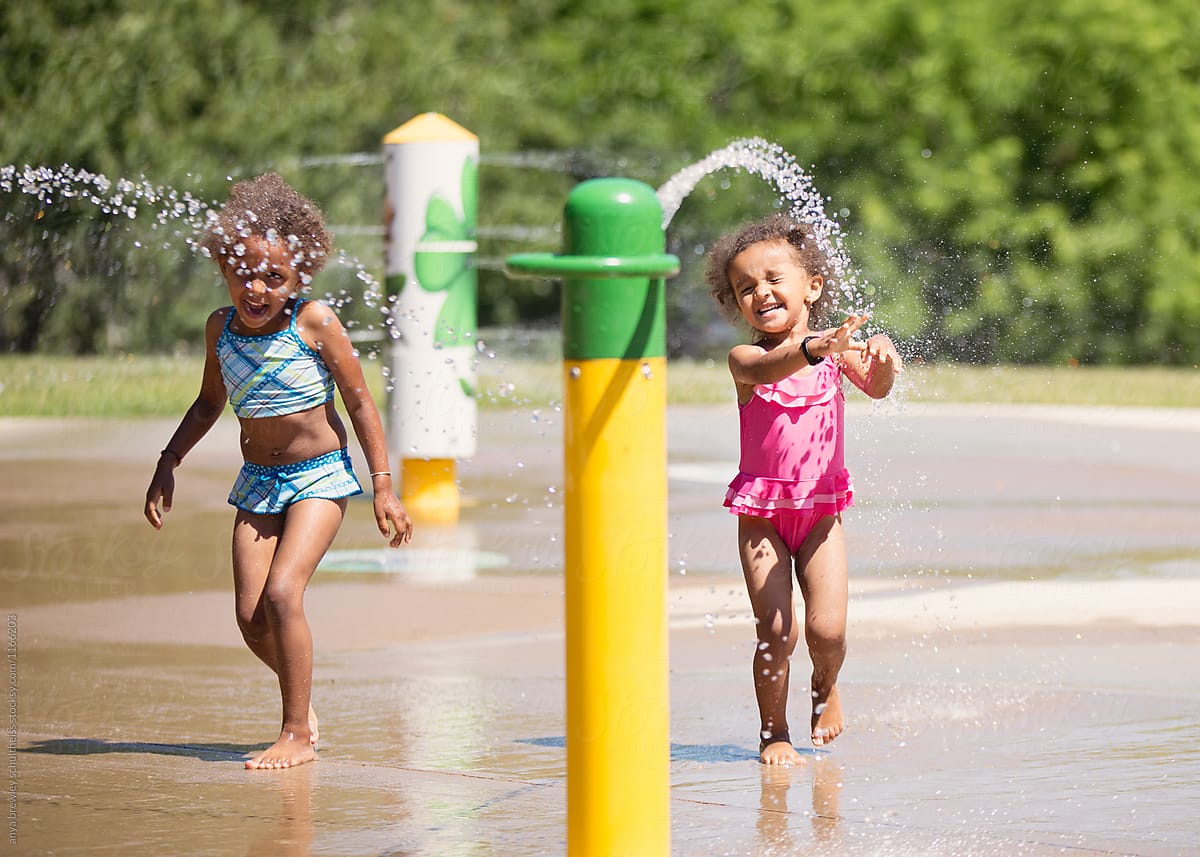 Children playing happily in the water at a splash pad