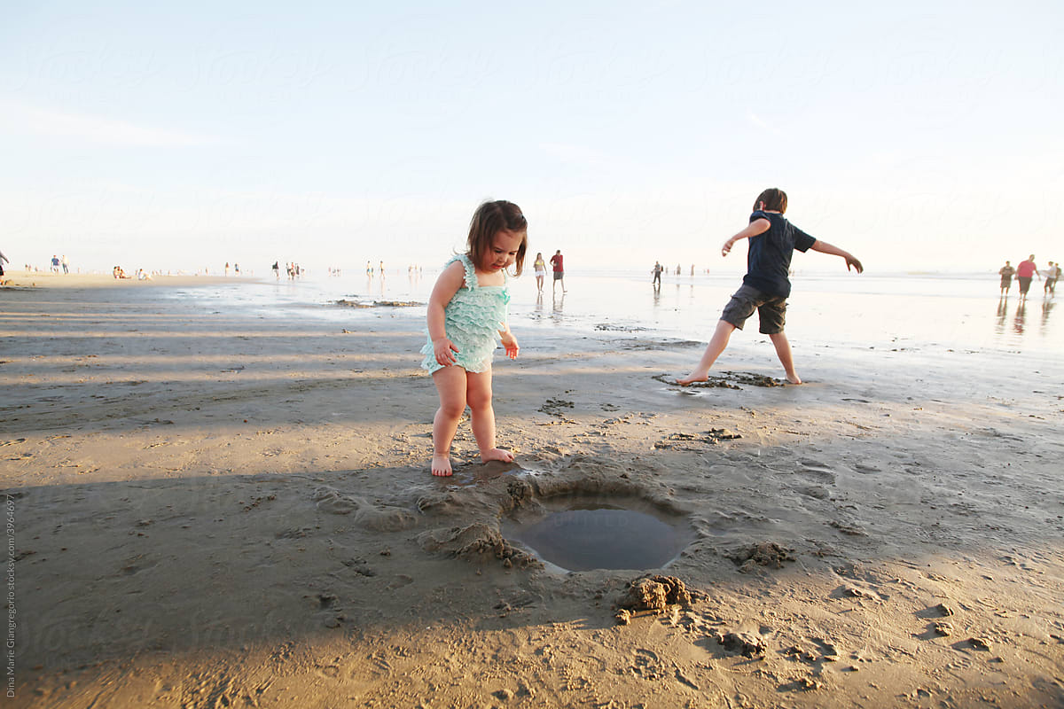 Boy and Girl Playing in the Wet Sand