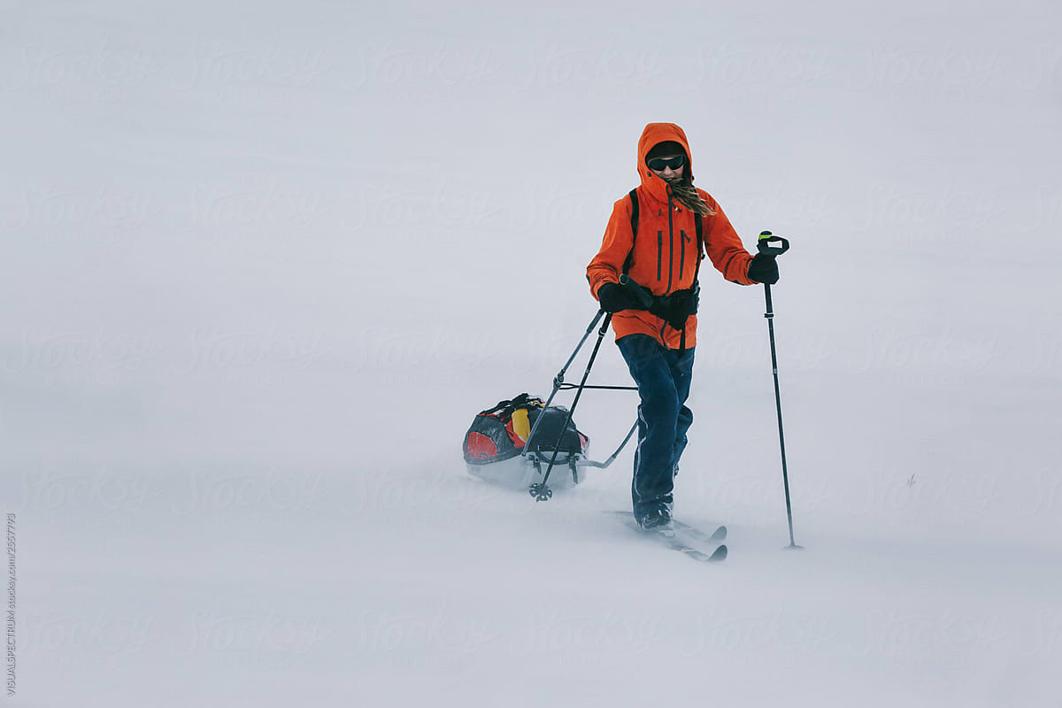 Adventurer Ski Hiking With Sled Through Stormy Lapland