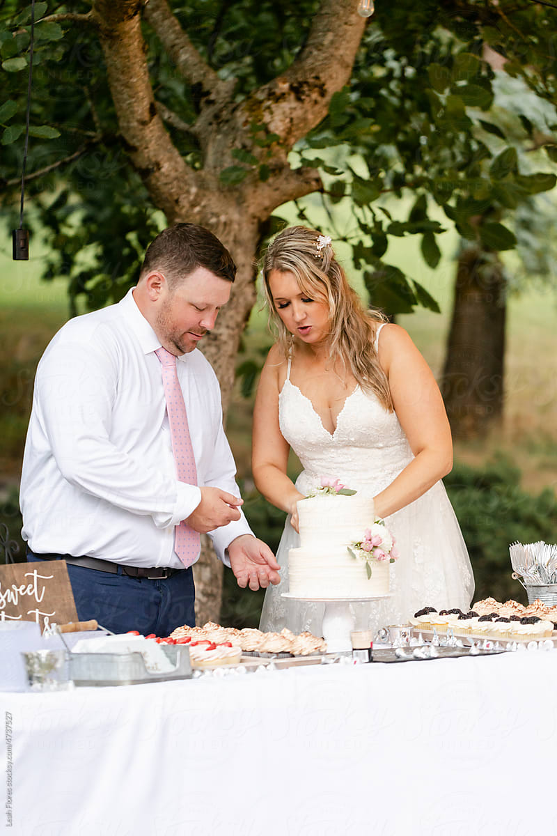 Couple Cutting Wedding Cake Together
