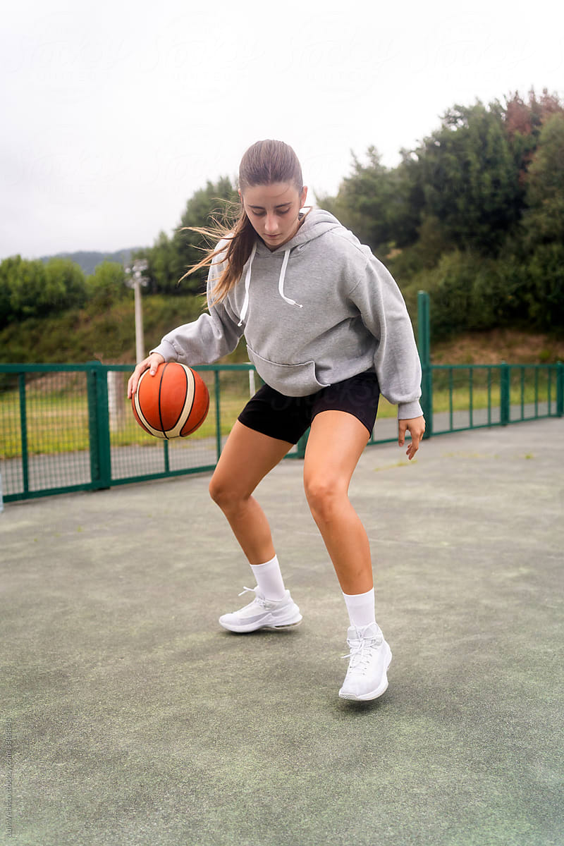 Athlete Girl Playing Basketball Outdoors.