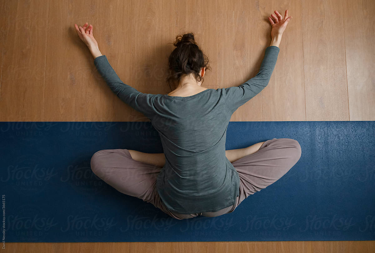 Relaxed woman doing Bound Angle yoga asana