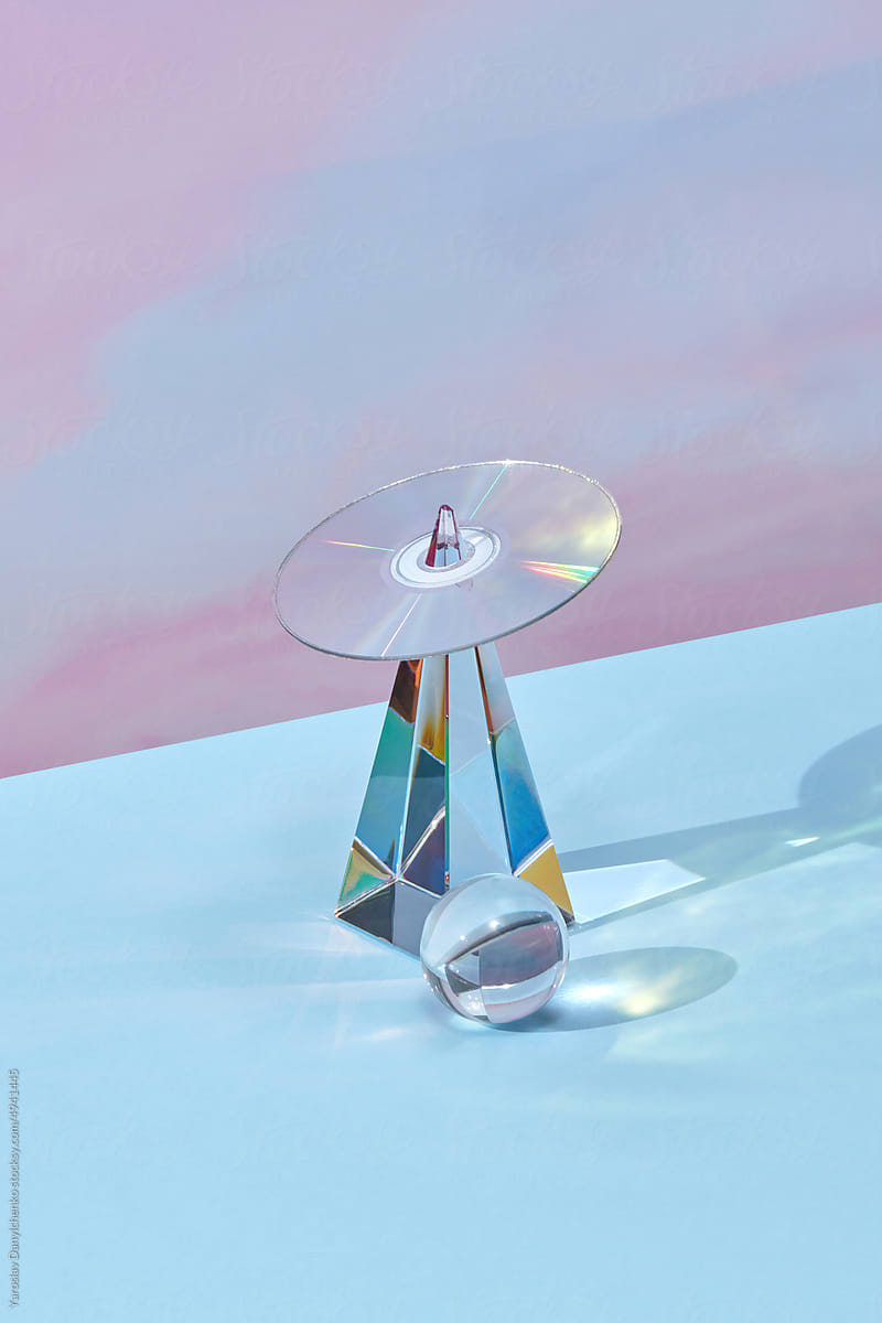 Retro CD on glass pyramid with glass sphere.