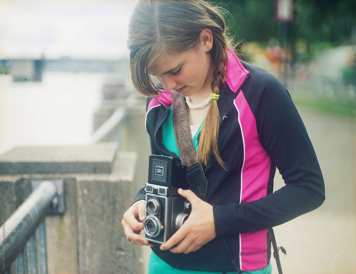 young  girl  holds film camera