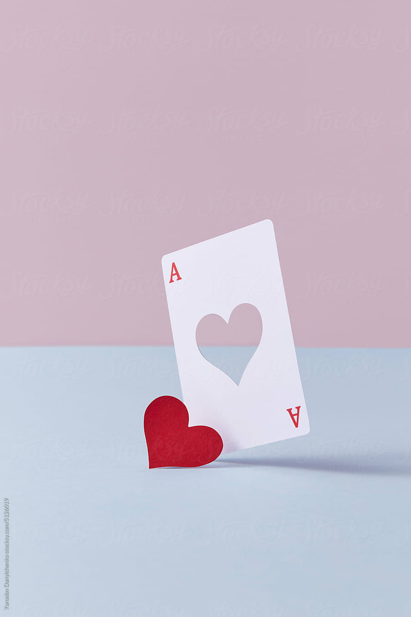 Ace card with cut red paper heart.