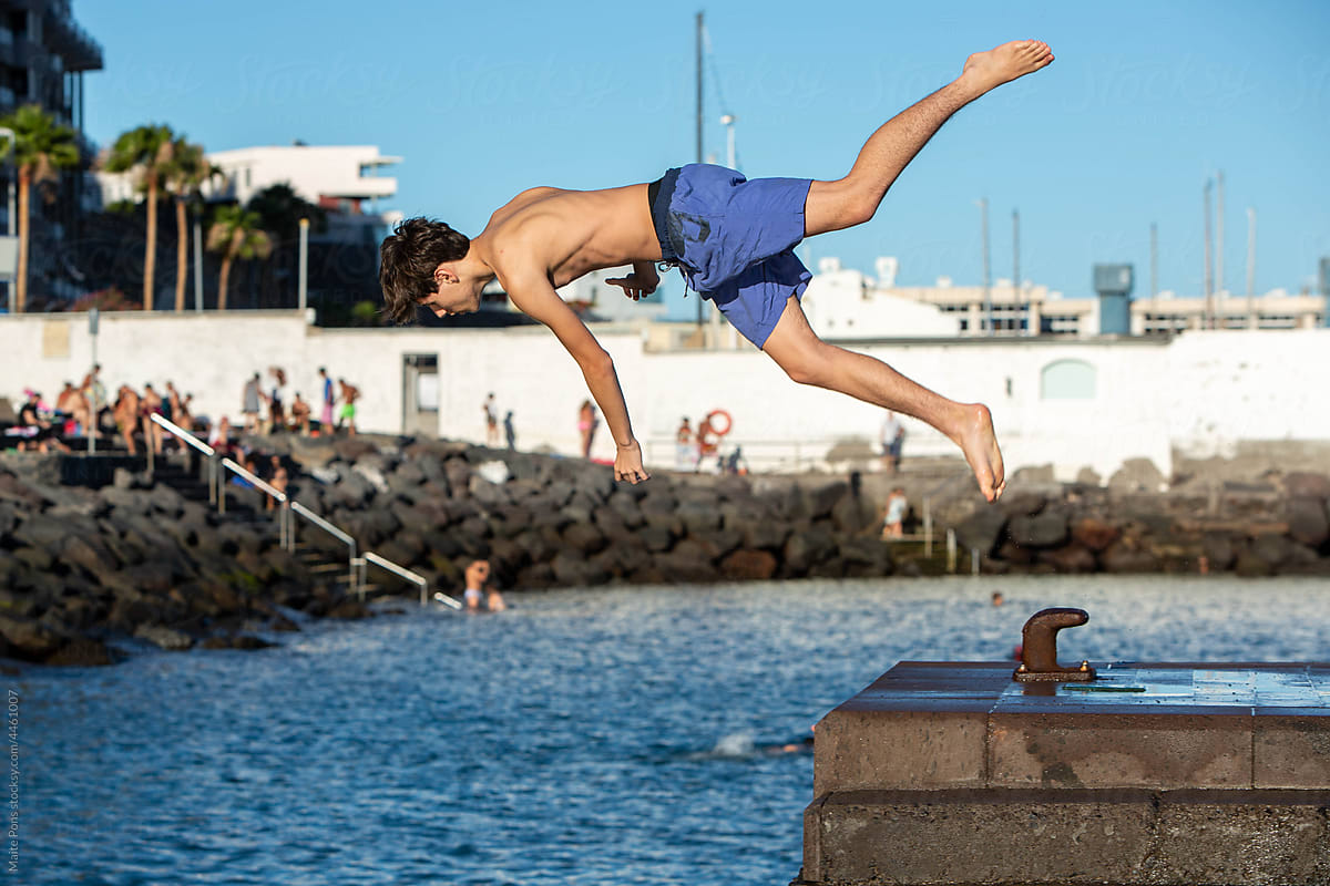 Teenage Boy Jumping from Pier