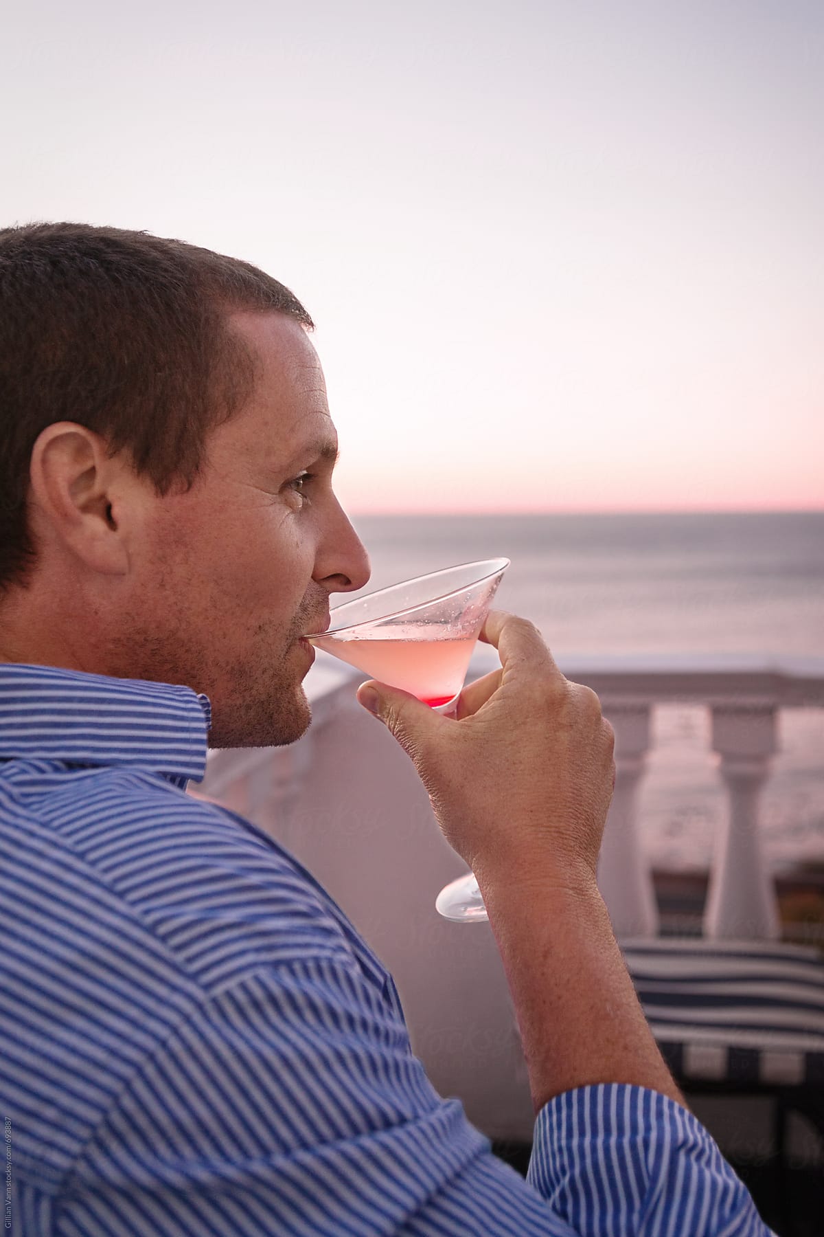 man drinking a cocktail