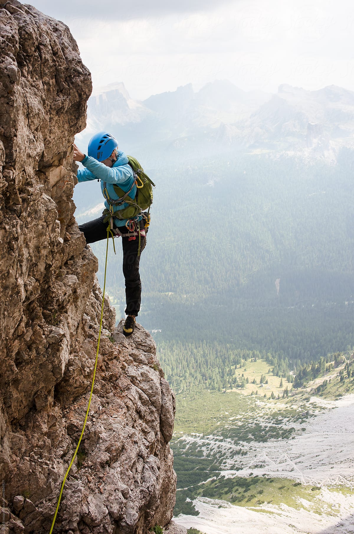Female alpinist rock climbing Tofana di Rozes route