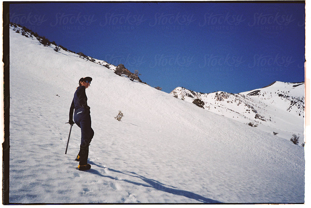Film photo: Woman on snowy mountain adventure