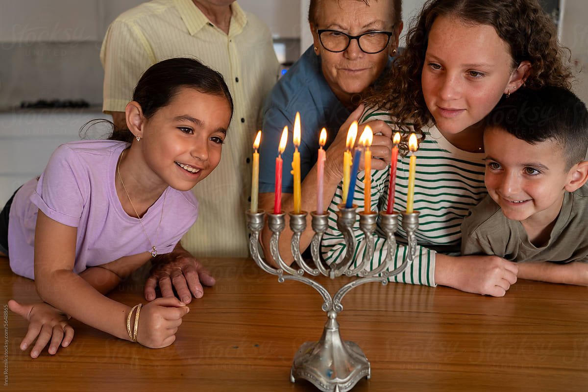 Multigenerational Hanukkah Celebration with Smiling Family.