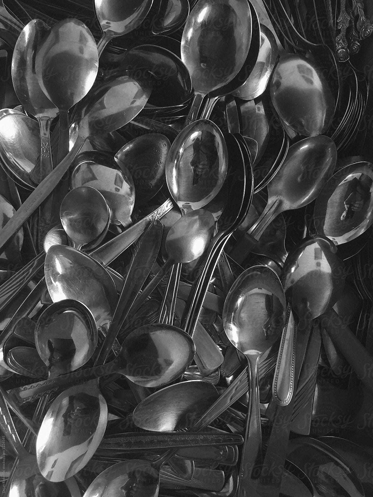 A bunch of spoons in a drawer.