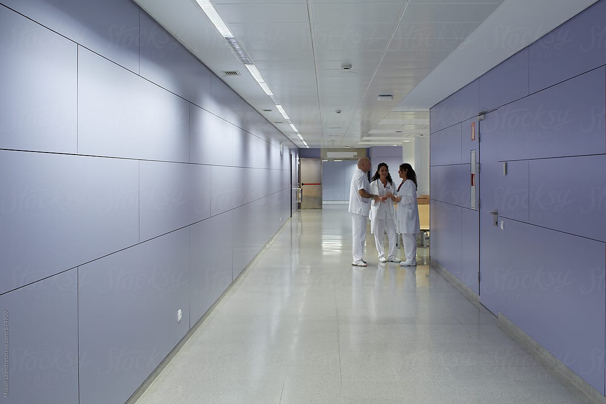 A group of medical staff talking in a hospital hall