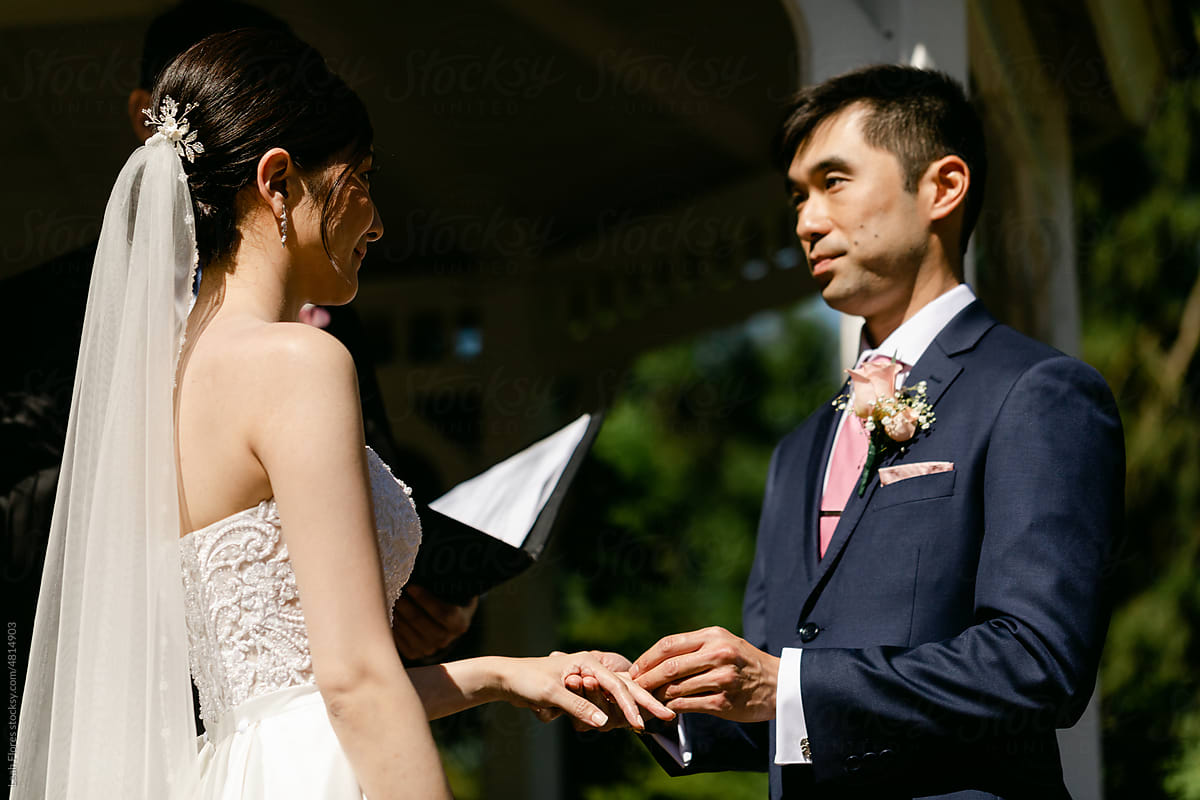 Groom Placing Wedding Ring On Bride S Finger Stock Image Everypixel