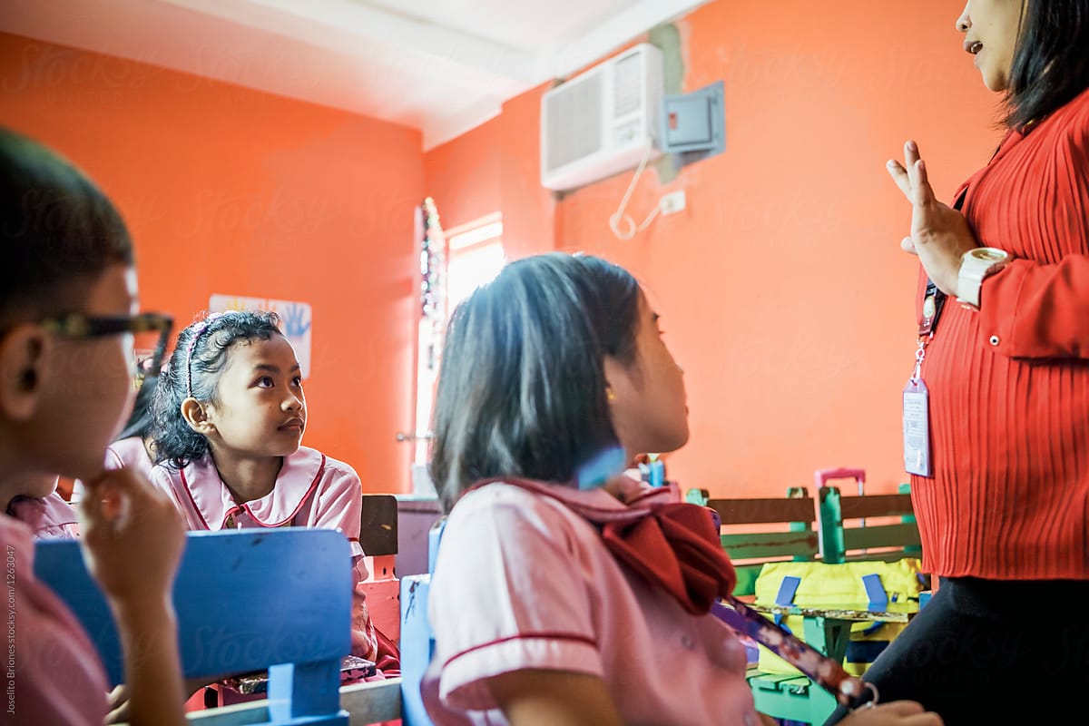 Filipino School Children Listening to Teacher in Classroom