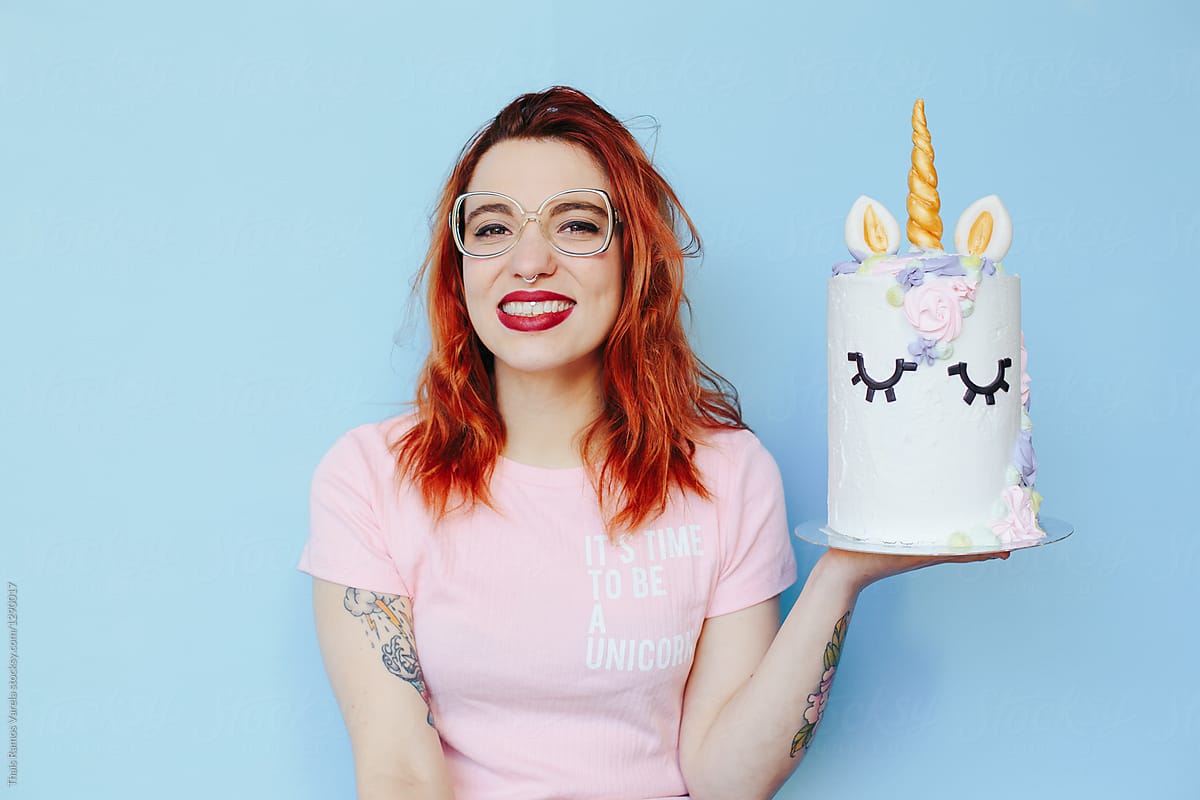 Young Redhead Woman Hanging A Unicorn Cake Del Colaborador De Stocksy 