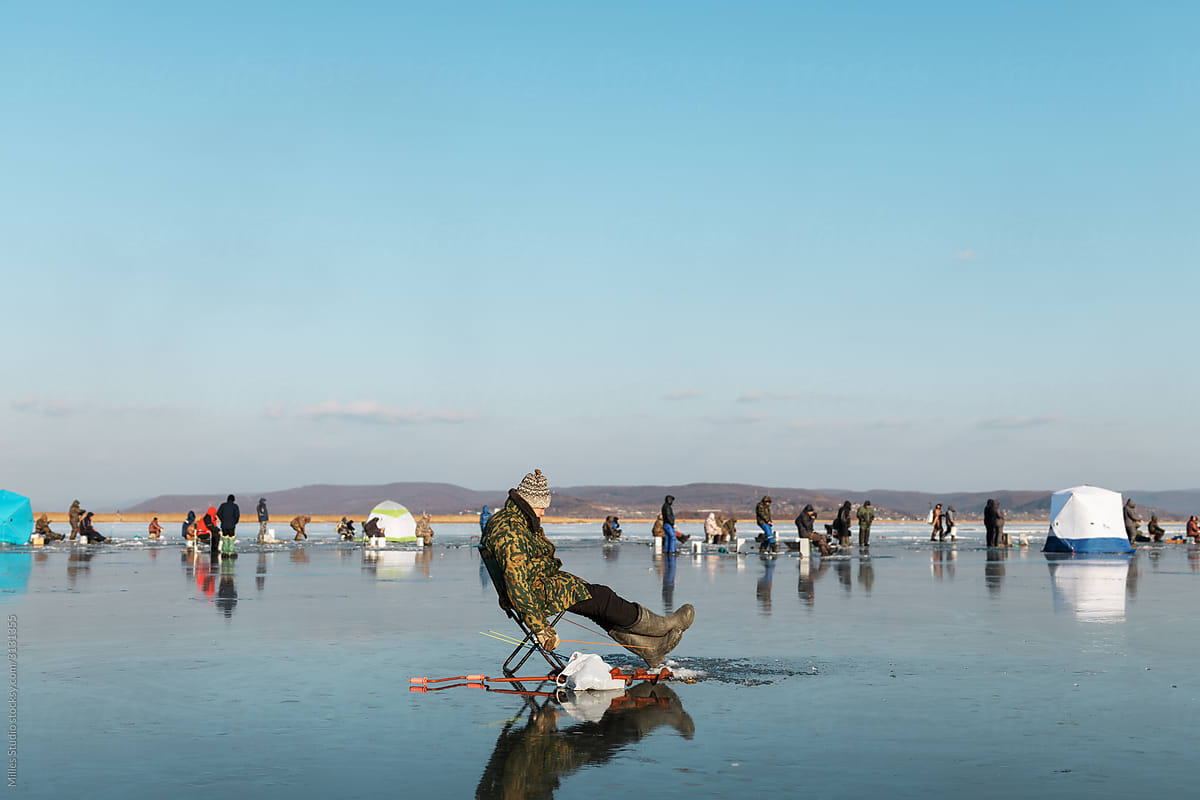 Man fishing on crowded ice