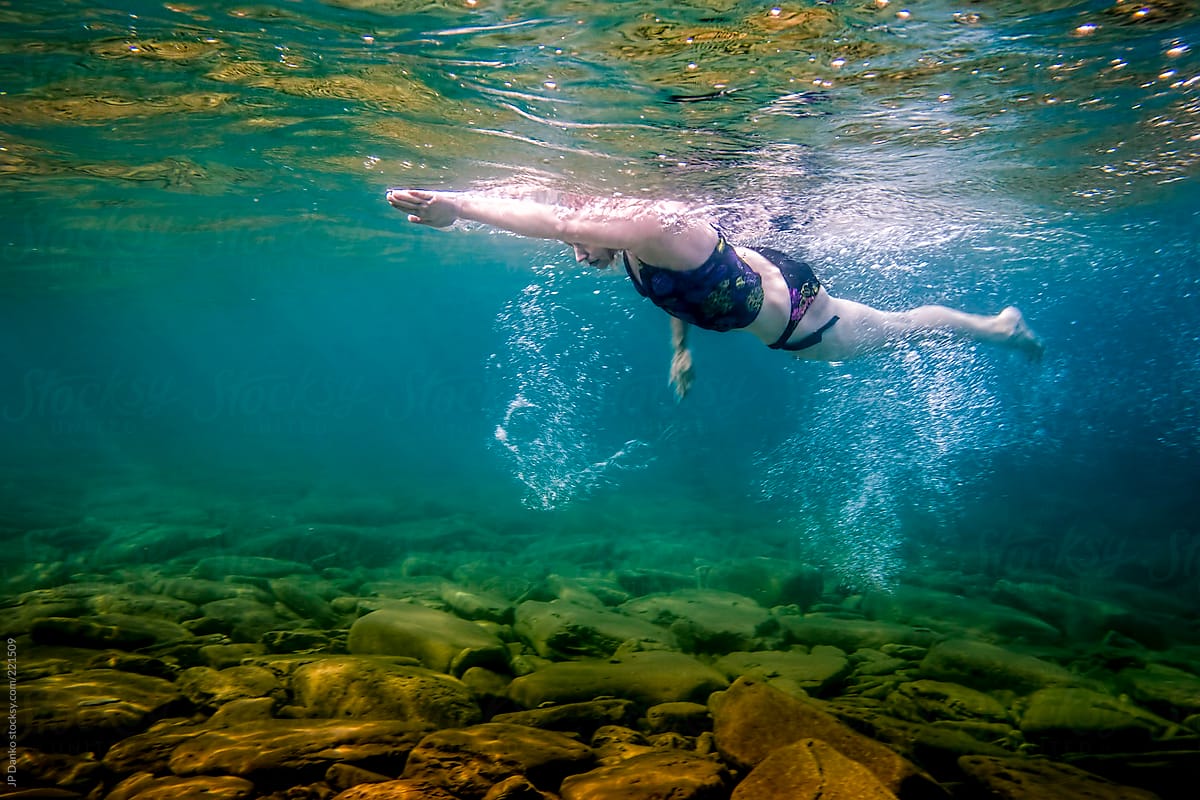 Woman Swimming Freestyle Underwater Training in Open Water