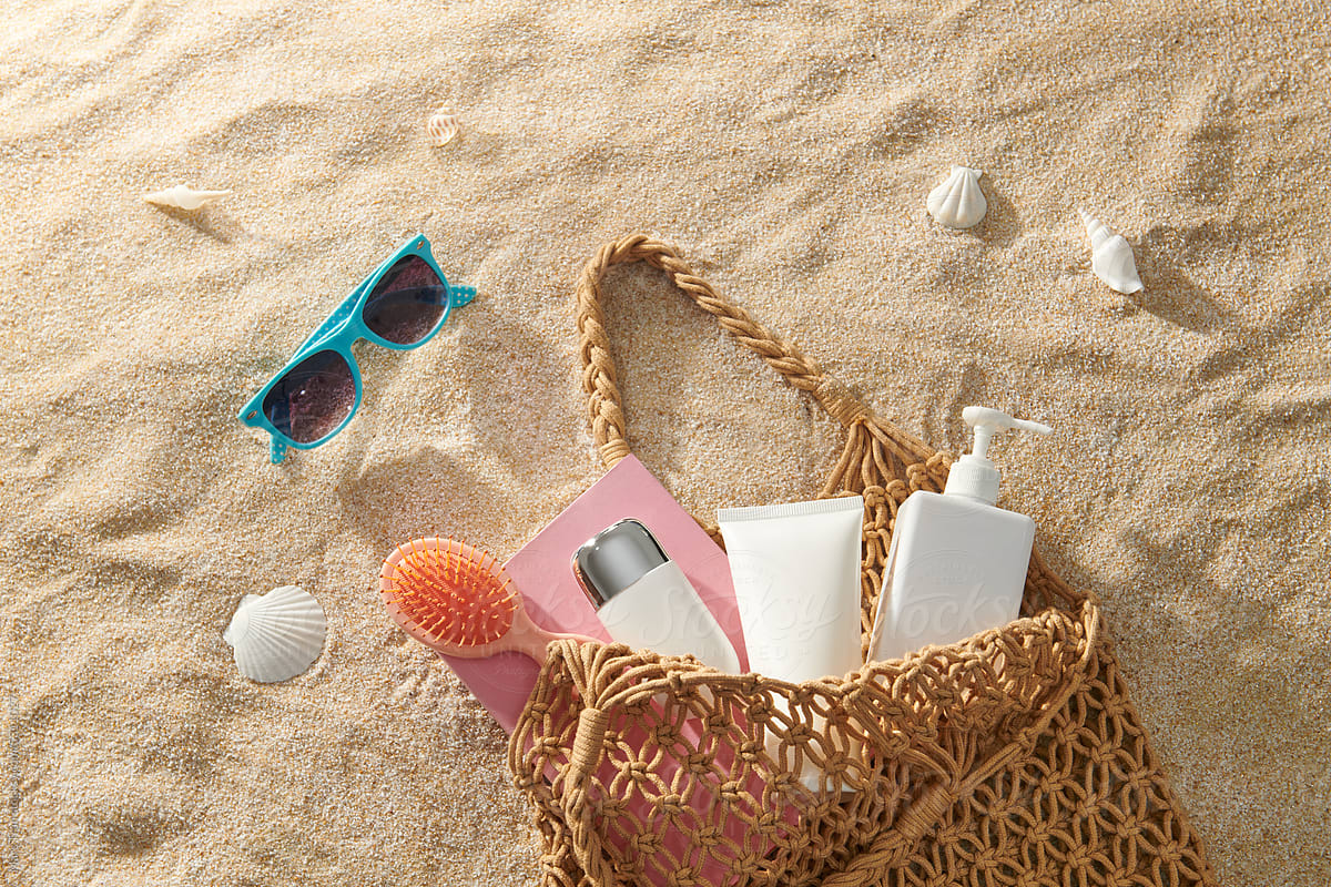 Composition with beach accessories and space for text on sand