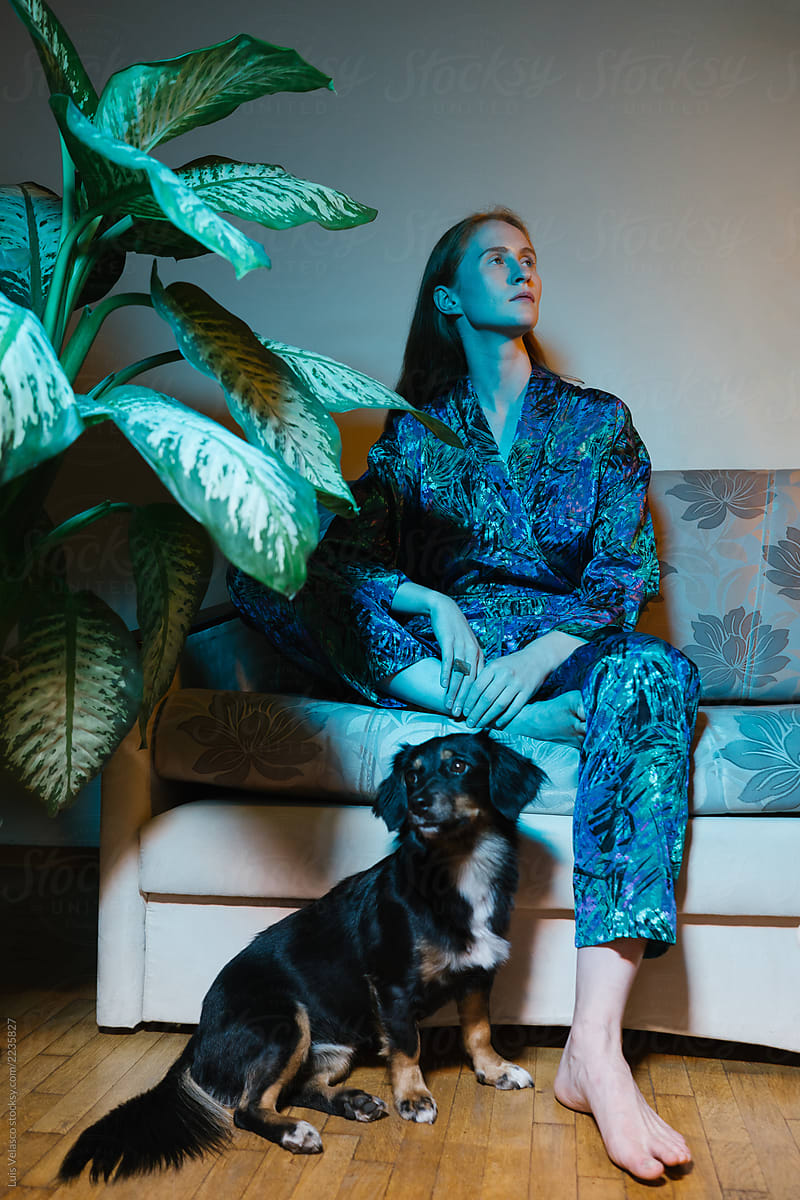 Elegant Woman With Her Dog On Blueish Lights.