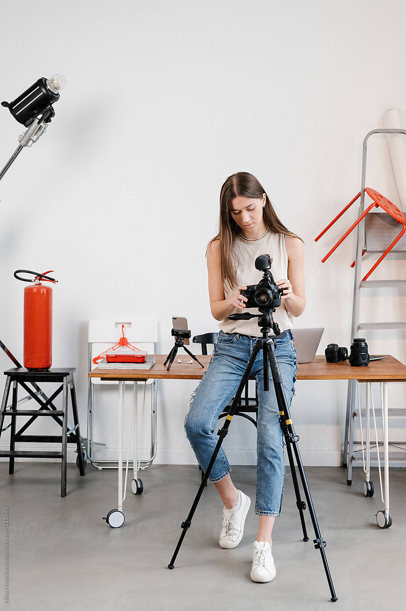 Woman setting up camera in studio