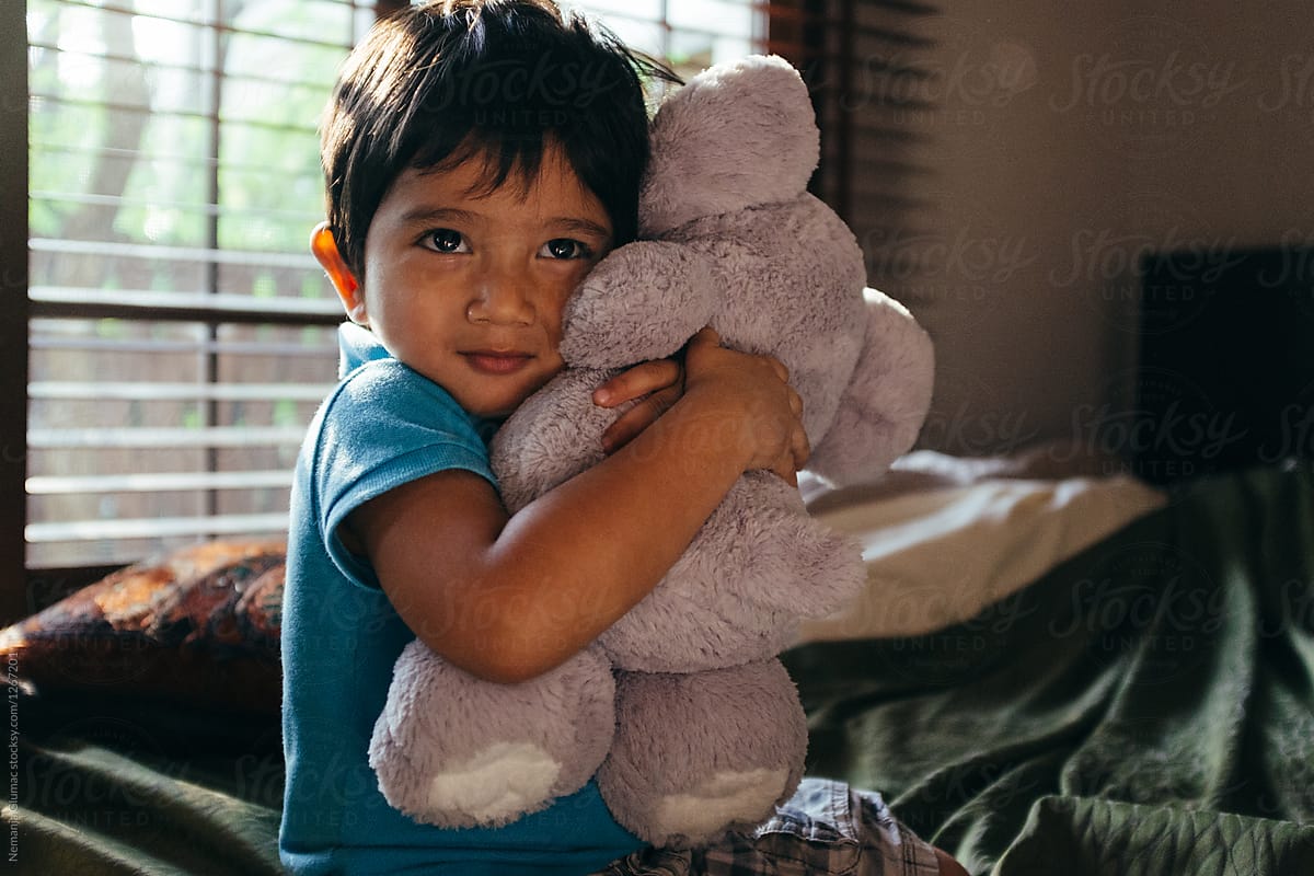 Adorable Indonesian Little Boy Hugging His Favourite Toy