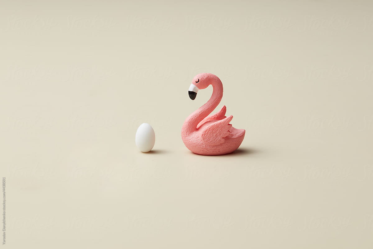 Figure of pink easter flamingo with white egg