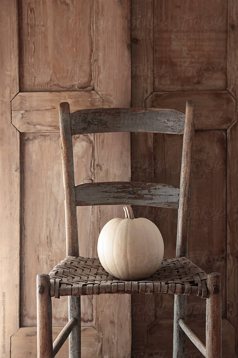 White pumpkin on old wooden chair