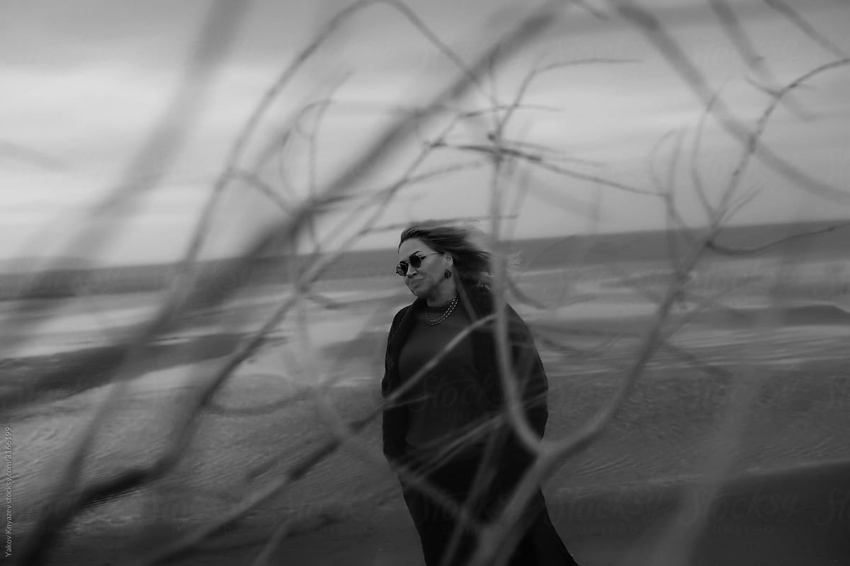Bw portrait of a senior woman on the empty beach