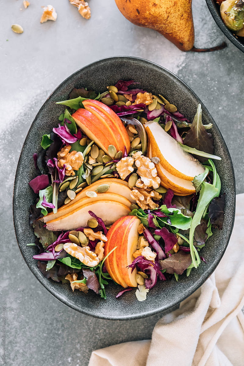 Delicious salad with apple, pear and walnuts