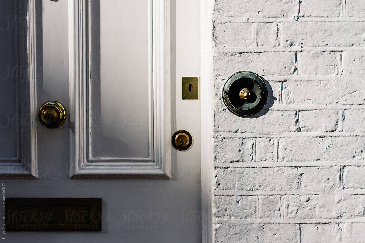 Doorbell and door furniture on a white house