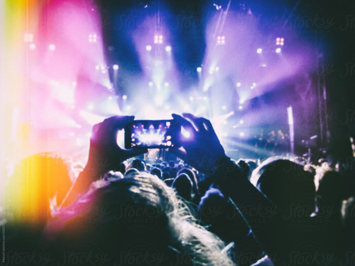 Someone at a concert taking a photo
