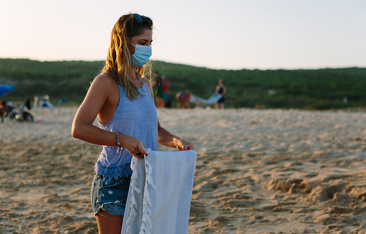 Woman folds beach towel