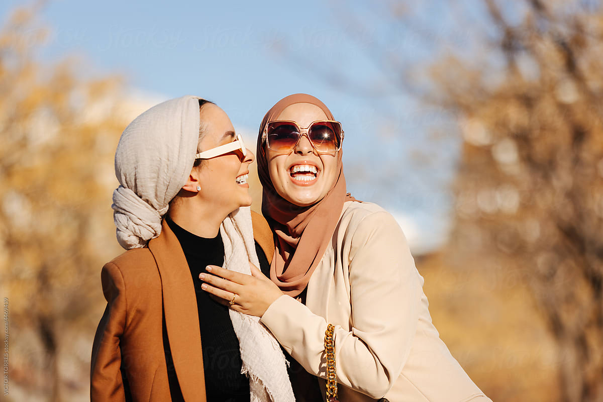 Cheerful muslim women in trendy clothes and sunglasses