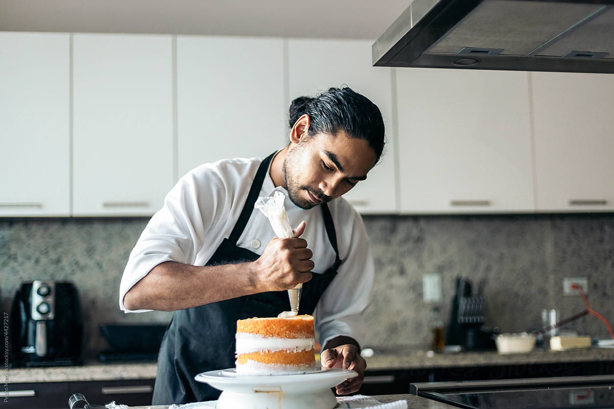 pastry chef assembling a cake