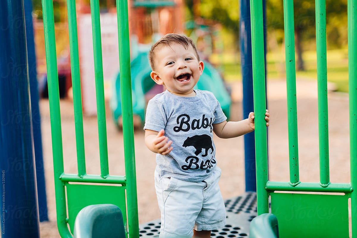 An adorble little boy playing on the playground / park