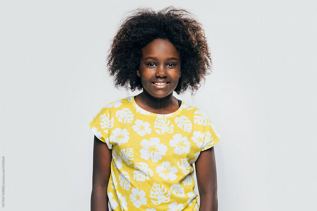 Happy Black Girl In Yellow Shirt by Stocksy Contributor VICTOR