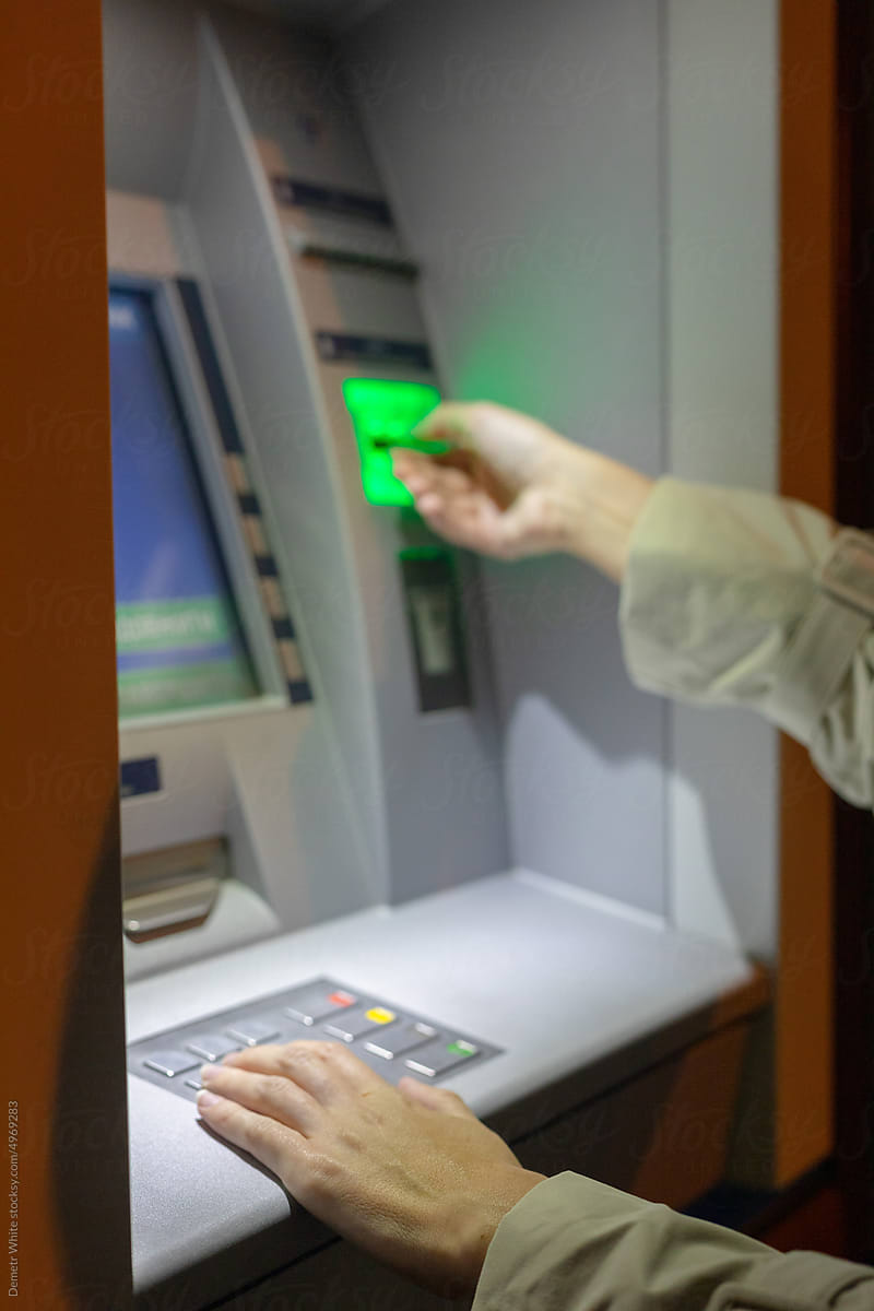 woman\'s hands at the ATM