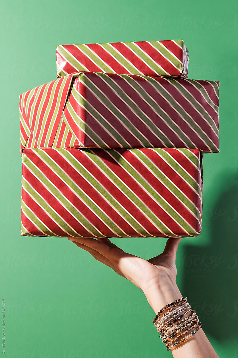 Woman\'s hand holding a pile of presents
