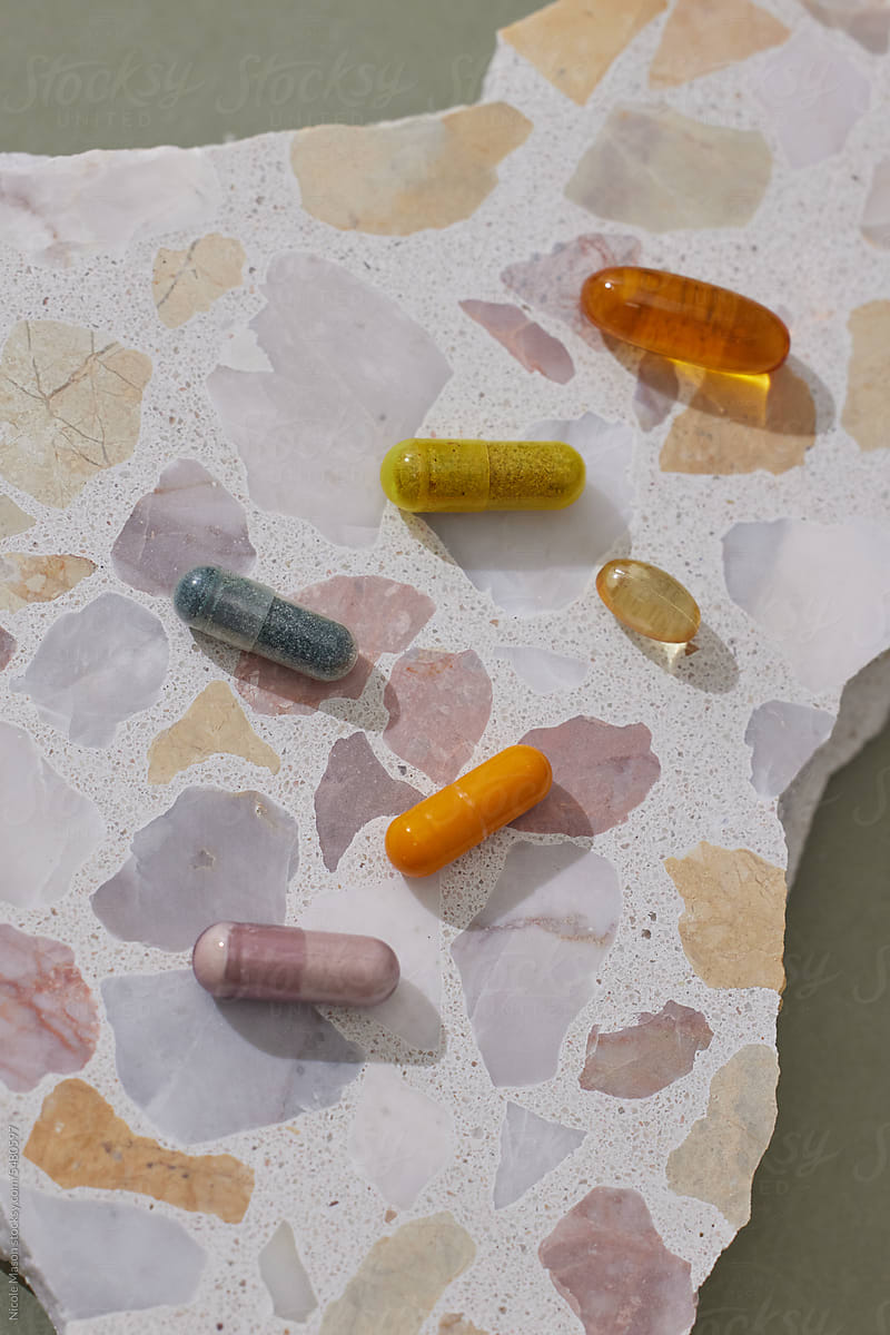 Vibrant Harmony: Colorful Supplement Pills on Terrazzo Surface