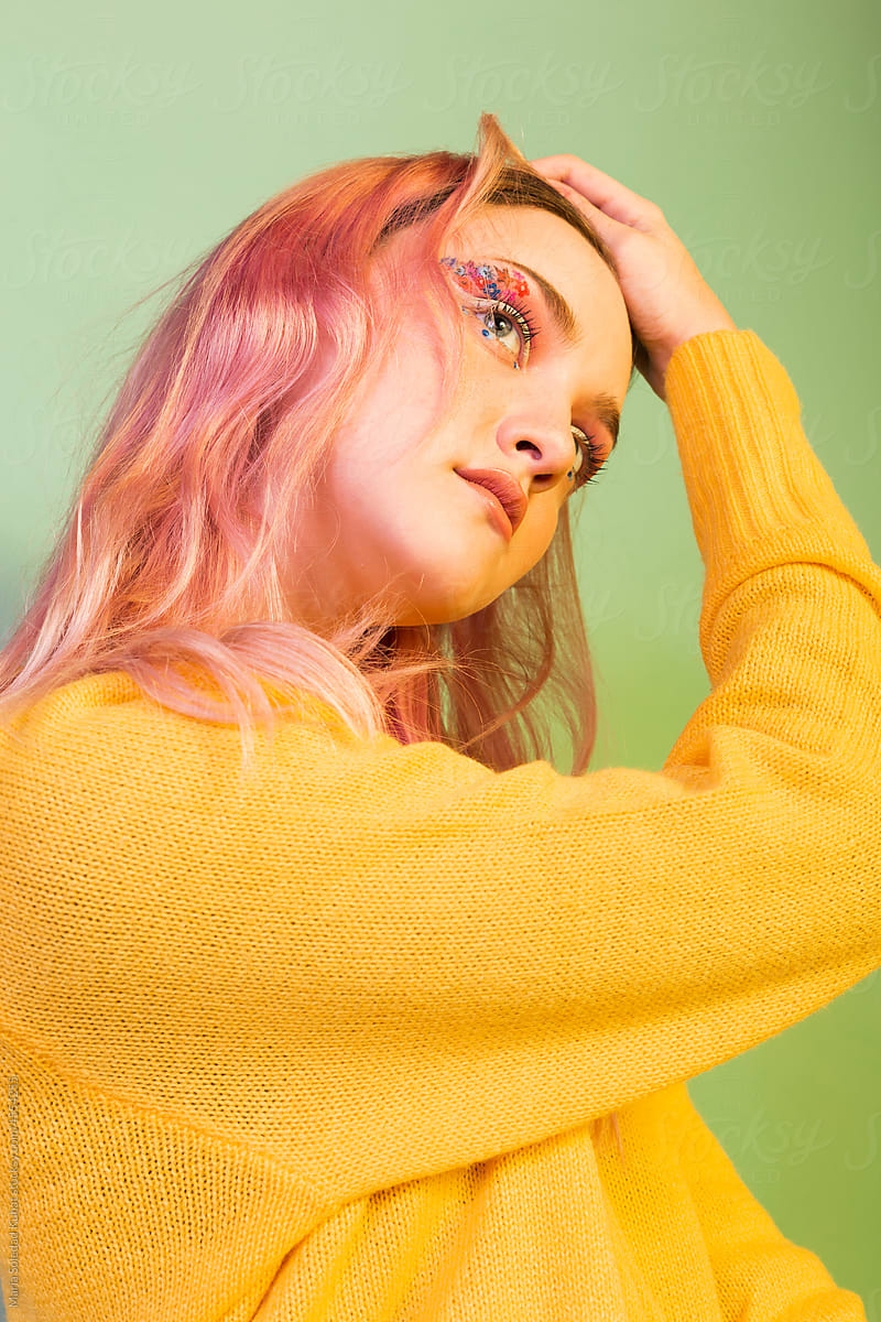 Portrait of a beautiful young girl with pink hair in the studio