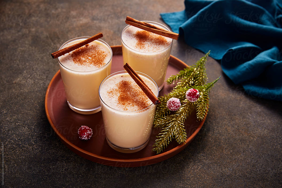 Glasses Of Eggnog On A Tray With Holiday Decorations by Stocksy  Contributor Darina Kopcok - Stocksy