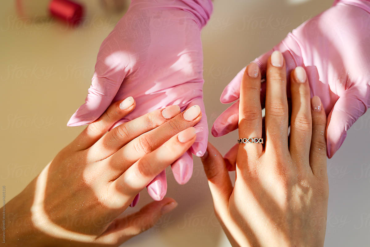 Fancy manicure with soft pink gel polish and a brilliant treatment