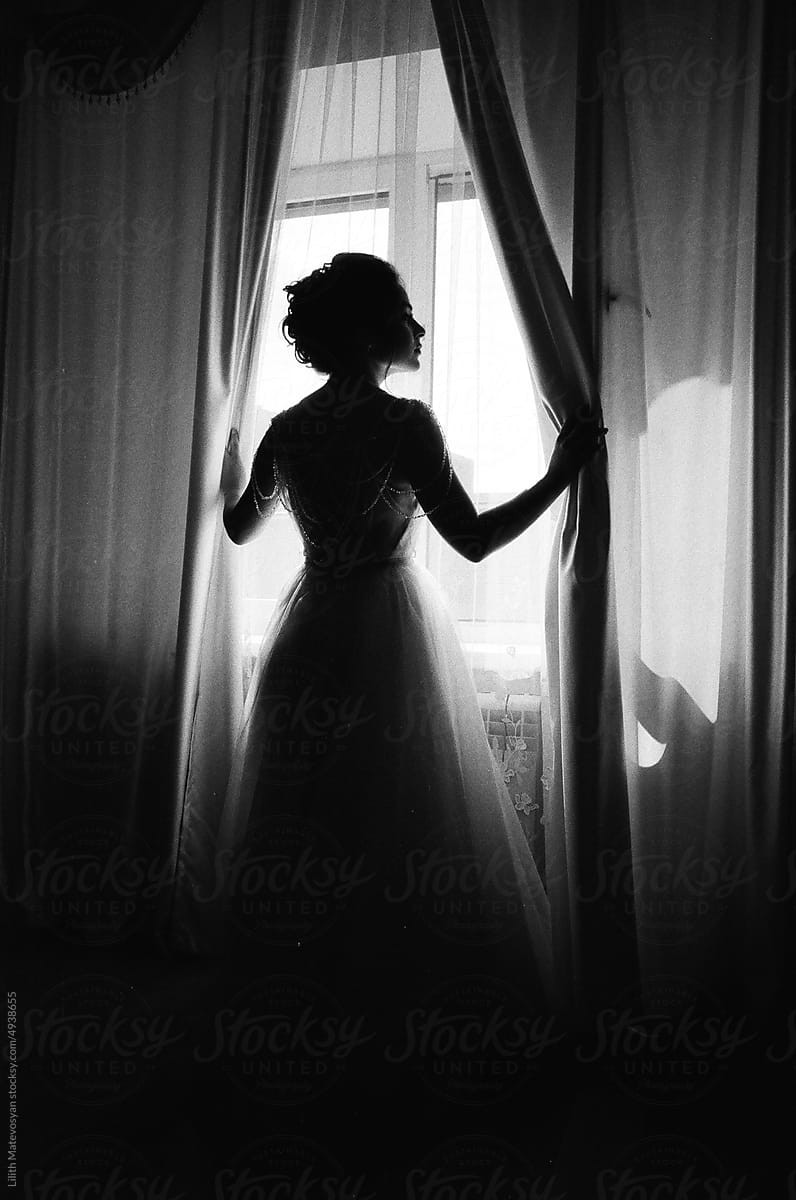 A bride in her room by the window