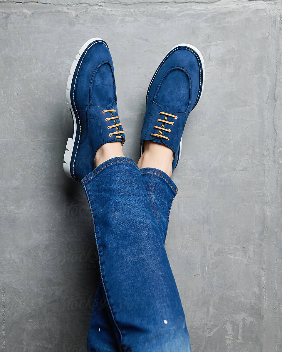 Men\'s legs in blue suede loafers
