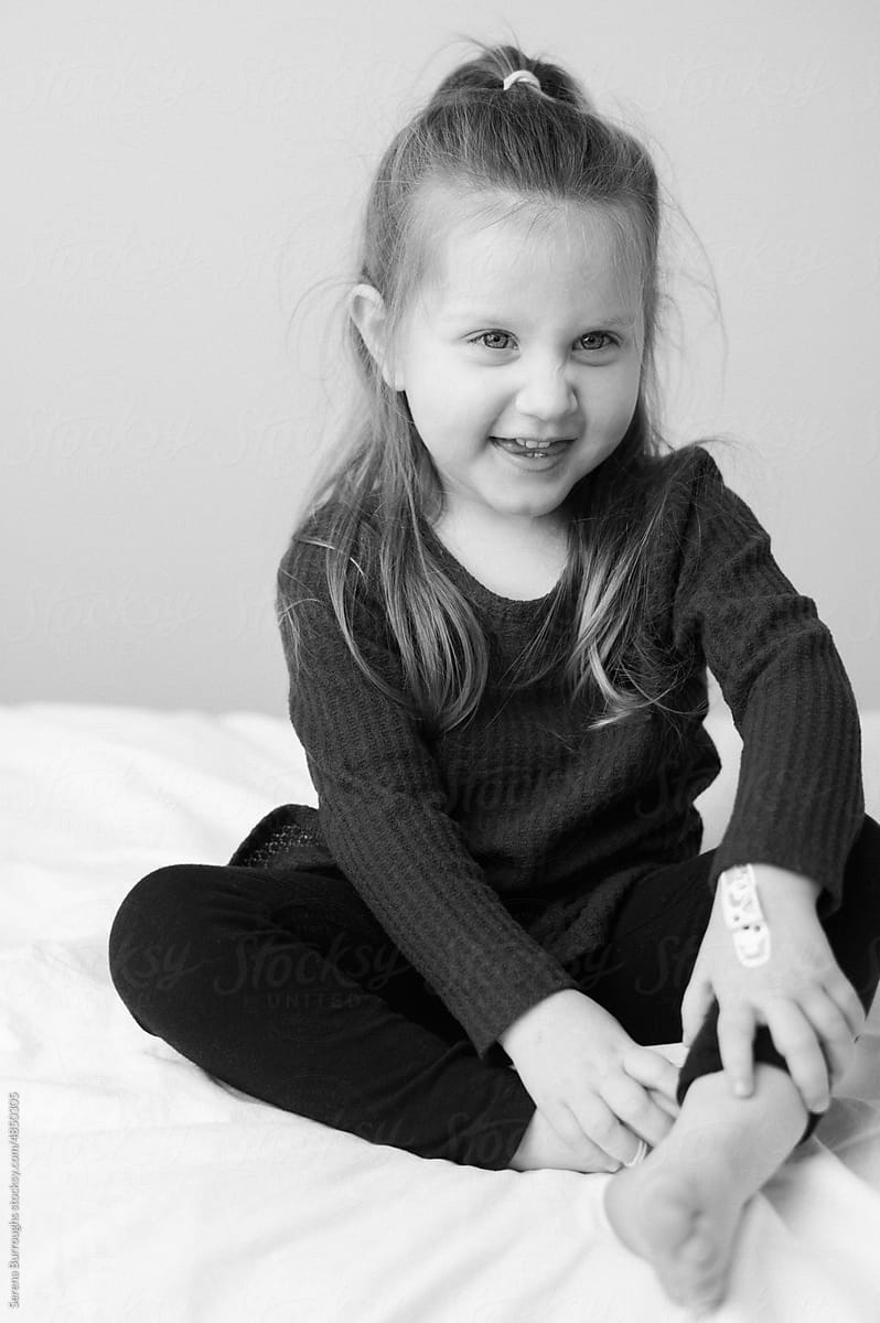 Portrait of an expressive funny smiling toddler girl