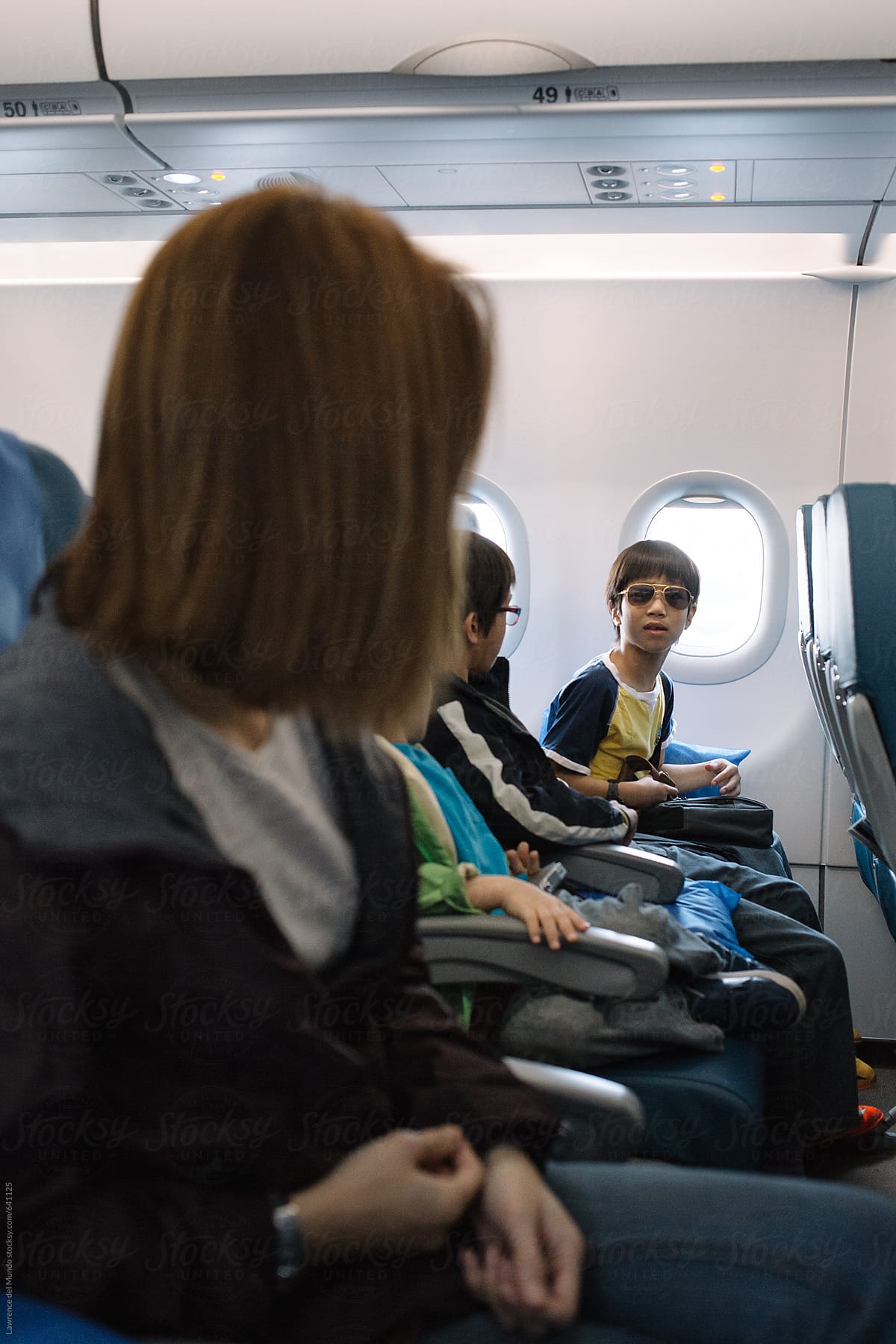 Mother giving last instructions to her son before airplane takes off